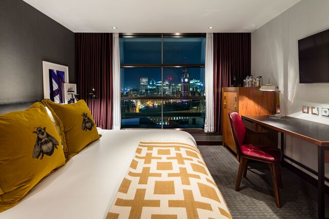 A hotel room with a city view at The Edwardian Manchester.