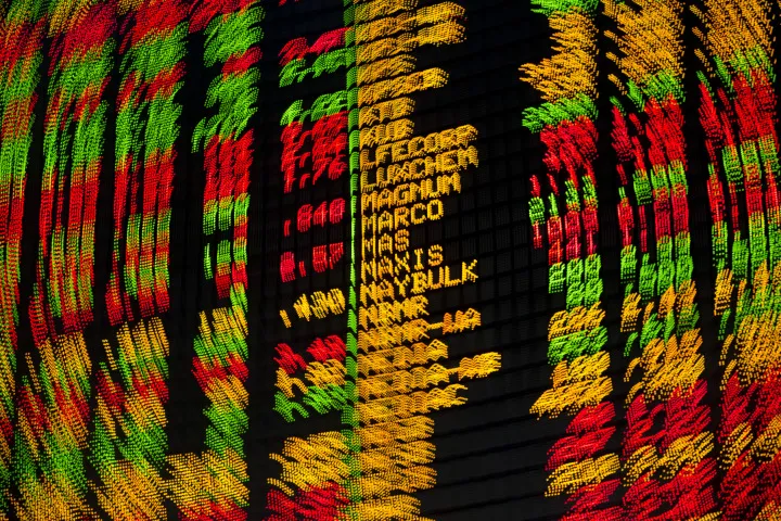 Stock prices are displayed on a board in the trading gallery at the RHB Investment Bank Bhd. headquarters in Kuala Lumpur, Malaysia, on Monday, July 21, 2014. CIMB Group Holdings Bhd. said it received central bank approval to begin merger discussions with RHB Capital Bhd. and Malaysia Building Society Bhd. to create the country’s biggest banking group by assets.