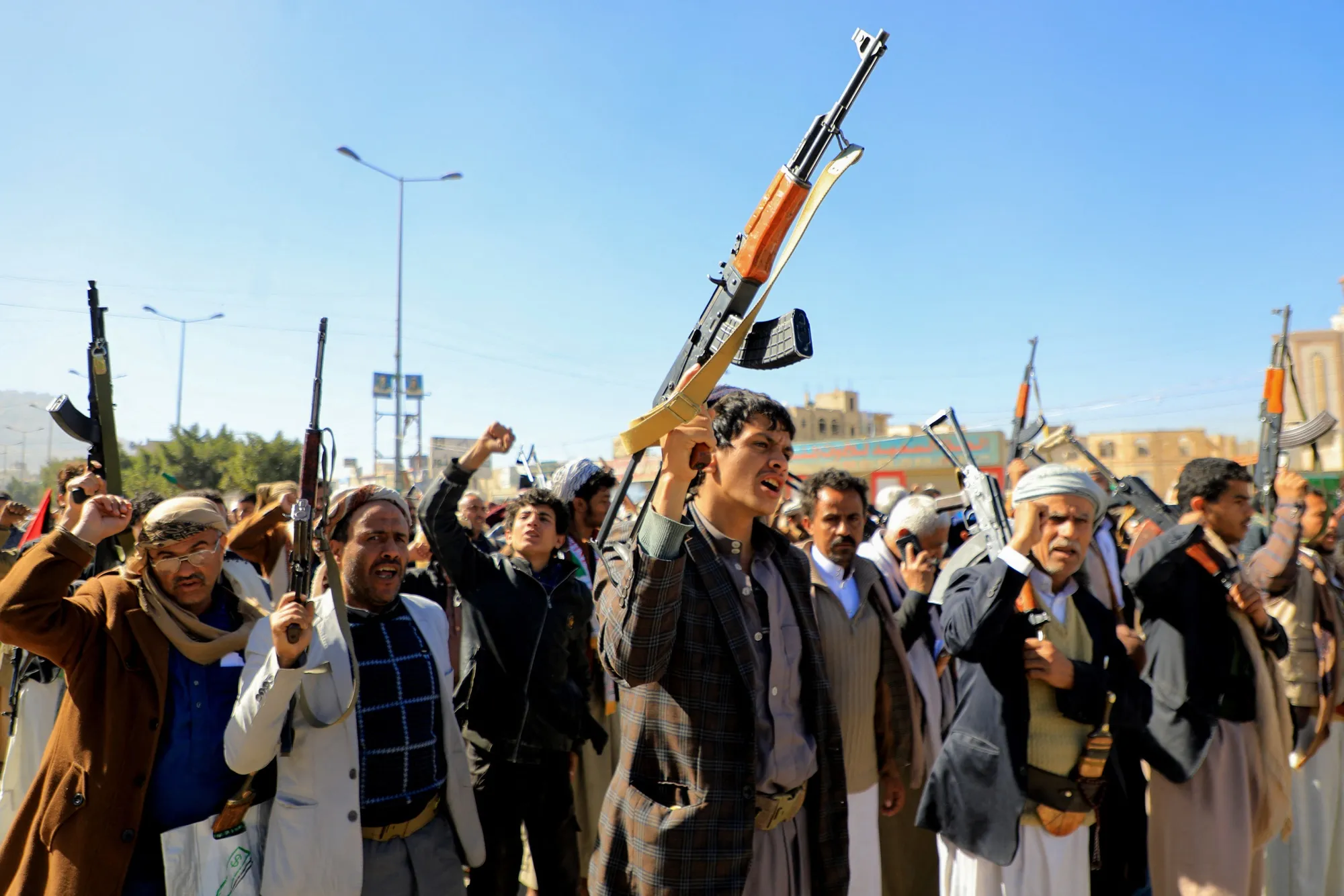Houthi fighters brandish their weapons during a march in solidarity with the Palestinian people in the Houthi-controlled capital Sanaa on January 11, 2024.