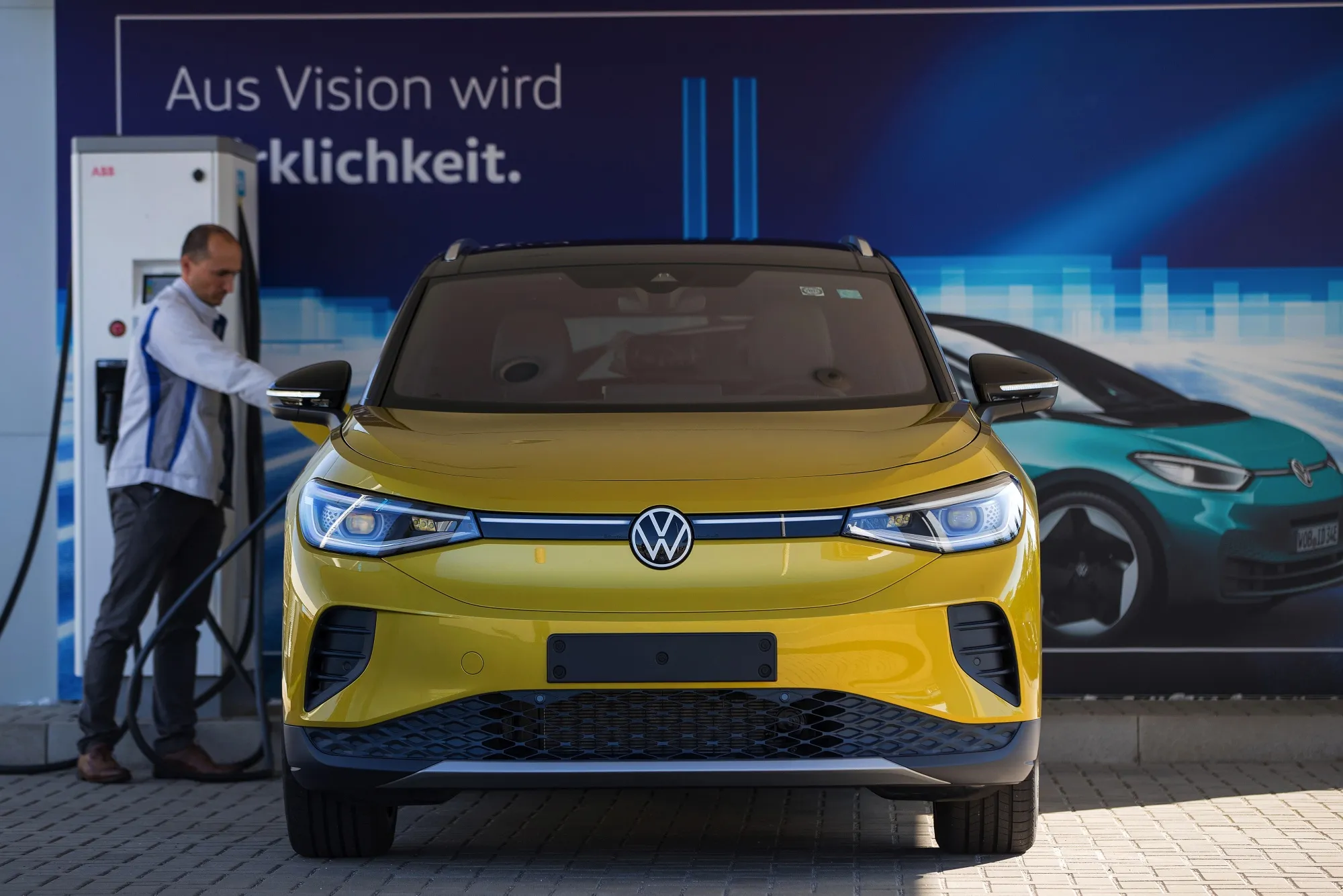 A Volkswagen employee plugging in an ID.4 electric sport&nbsp;utility vehicle at the automaker’s factory in Zwickau, Germany.
