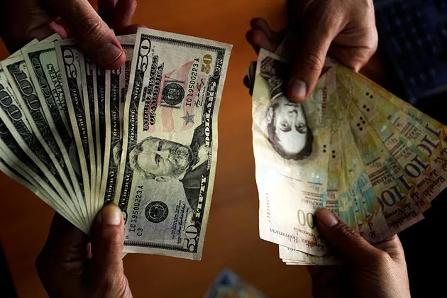 U.S. dollar and Venezuelan Bolivares notes being exchanged in Caracas on July 16