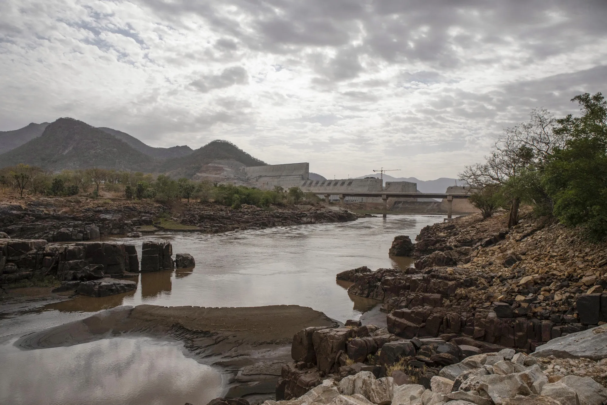 The Blue Nile flows as the&nbsp;Grand Ethiopian Renaissance Dam stands beyond in the Benishangul-Gumuz Region of Ethiopia during construction in 2019.&nbsp;