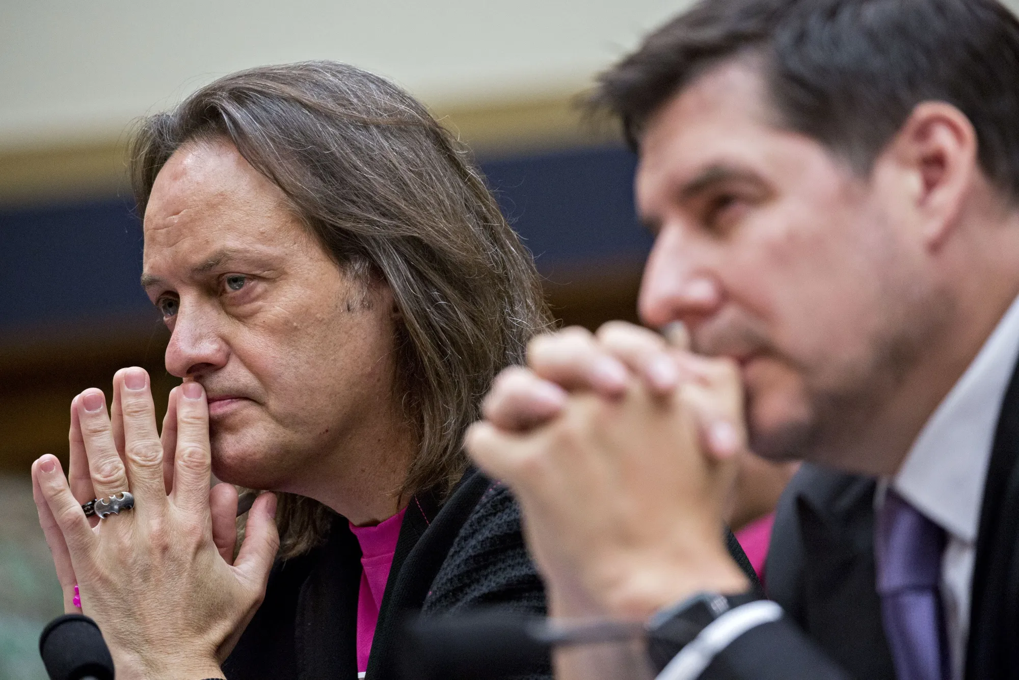 John Legere, left, and Marcelo Claure listen during a House Judiciary Subcommittee hearing in Washington on March 12.