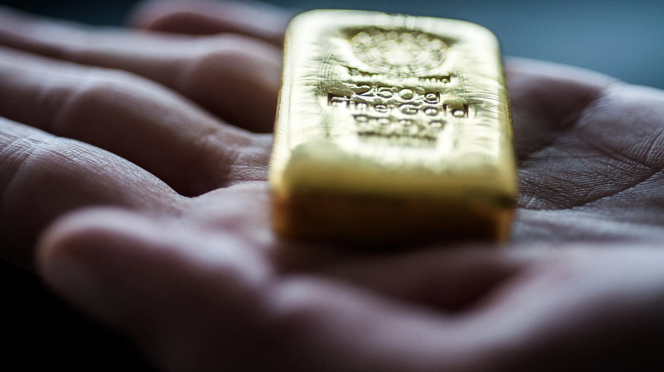 An employee holds a two hundred and fifty gram gold bar in this arranged photograph at Solar Capital Gold Zrt. in Budapest, Hungary, on Thursday, March 10, 2016. Gold advanced to the highest level in a year after the European Central Bank indicated it wouldn't cut interest rates further, boosting the euro and making dollar-denominated bullion less expensive for investors.
