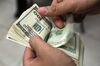 An employee counts a stack of U.S. one hundred dollar bills inside a currency exchange center in Mexico City, Mexico, on Tuesday, July 9, 2013. Mexico’s peso rose for the first time in three days on July 11 after Federal Reserve Chairman Ben S. Bernanke called for maintaining a U.S. stimulus program that has boosted demand for the Latin American country’s securities.