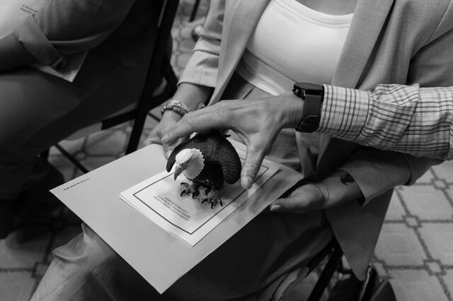 Tatiana keeps a miniature statue of an American bald eagle on her lap during the naturalization ceremony. 