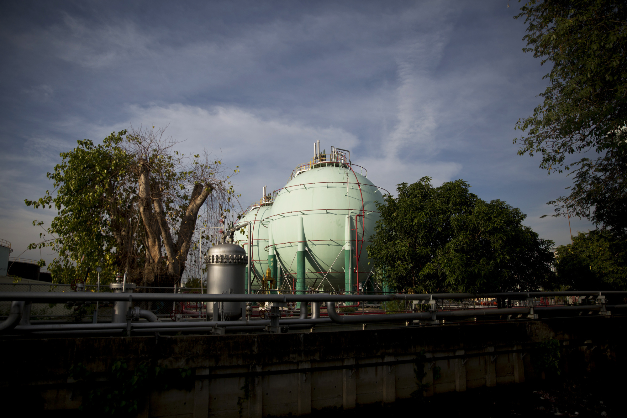 Petroleum storage containers at the Bangchak petroleum terminal in Bangkok. Photographer: Brent Lewin