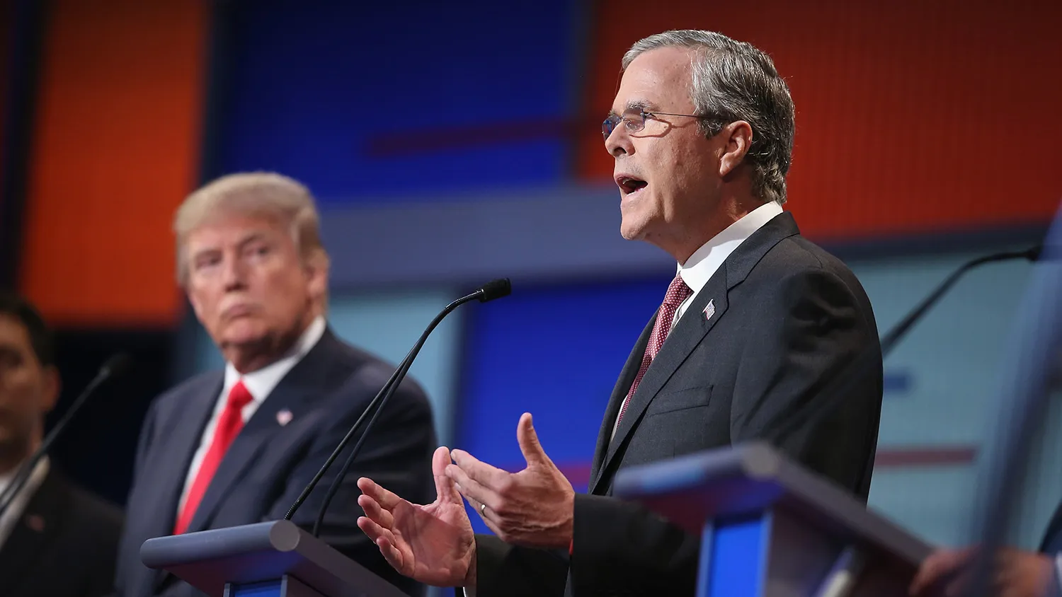 CLEVELAND, OH - AUGUST 06: Republican presidential candidate Donald Trump listens as Jeb Bush (R) fields a question during the first Republican presidential debate hosted by Fox News and Facebook at the Quicken Loans Arena on August 6, 2015 in Cleveland, Ohio. The top ten GOP candidates were selected to participate in the debate based on their rank in an average of the five most recent political polls.
