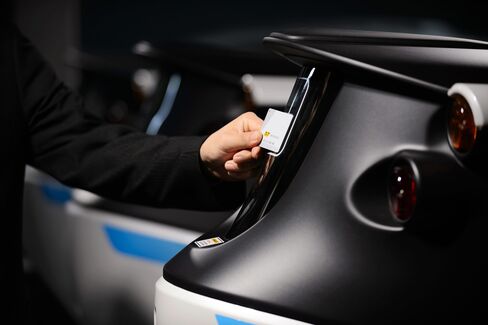 A Park24 employee unlocks a car with a key card.
