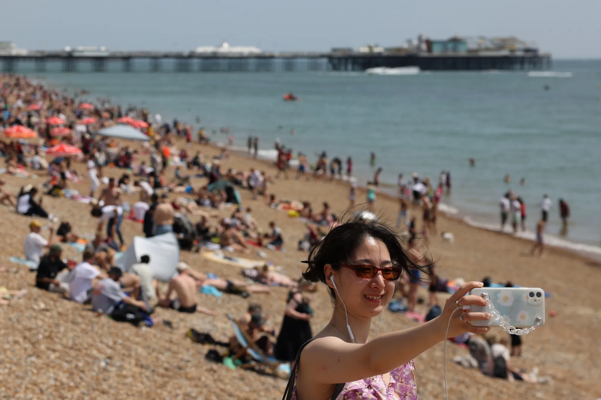 People enjoy the hot weather at Brighton beach.