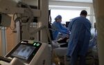X-ray technicians take a chest x-ray of a Covid-19 patient on the Intensive Care Unit floor at a hospital in Hartford, Connecticut.
