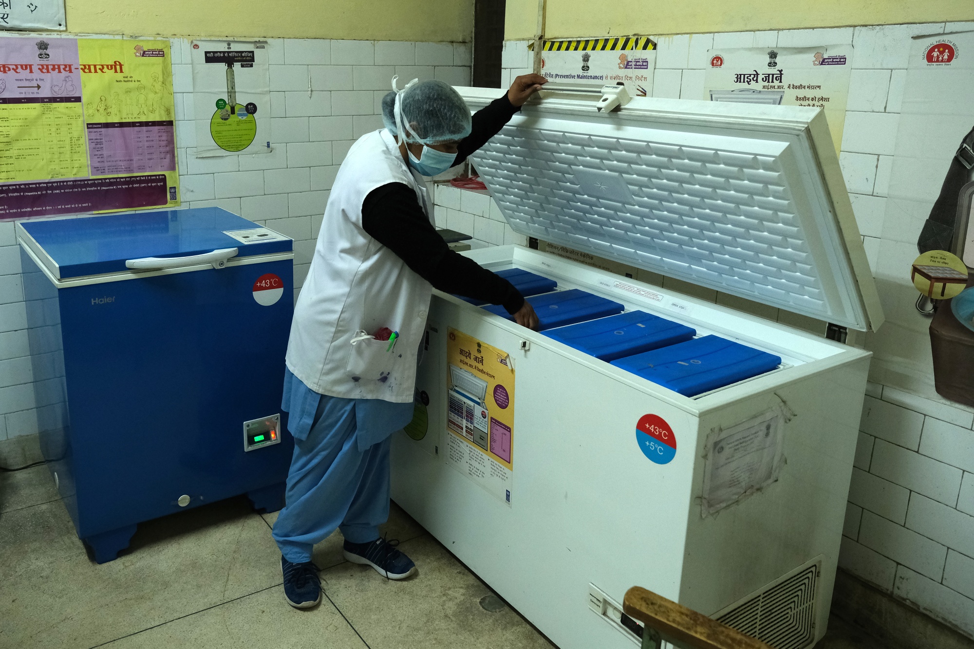 A health worker opens a freezer during a vacuum test of the Covid-19 vaccine in Delhi on January 2.