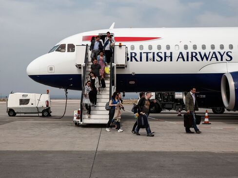Passengers disembark from a BA flight at Santorini airport in Greece.