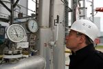 An employee checks gauges at the Beregovaya compressor station, part of the Blue Stream gas pipeline, a joint venture between OAO Gazprom and Eni SpA, in Gelendzhik, Russia.