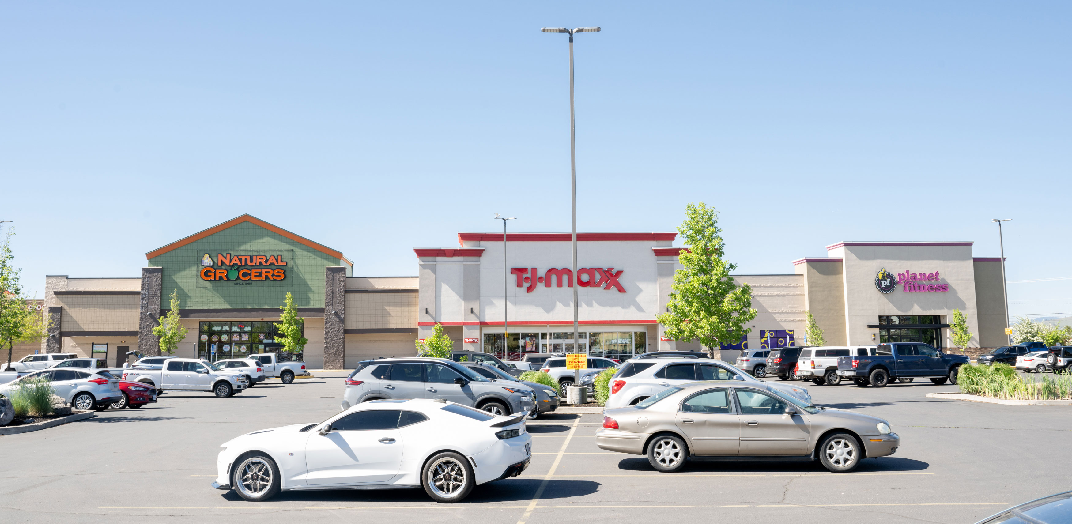 The exterior or a former Safeway, which has now been split up into a Planet Fitness, TJ MAXX, and Natural Grocers in Klamath Falls, OR.