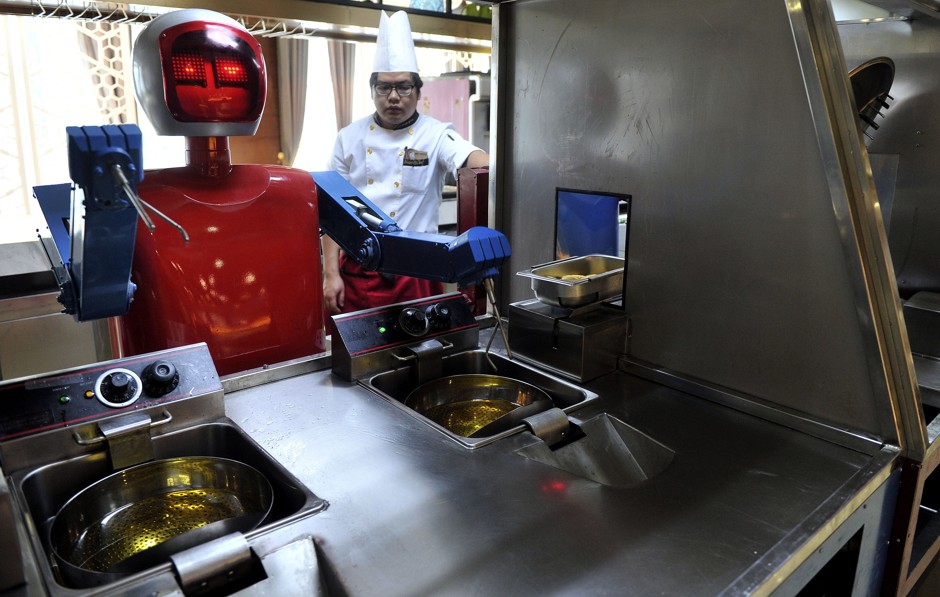 A robot chef takes over in a restaurant in the Chinese city of Hefei. But a human cook still needs to supervise. 