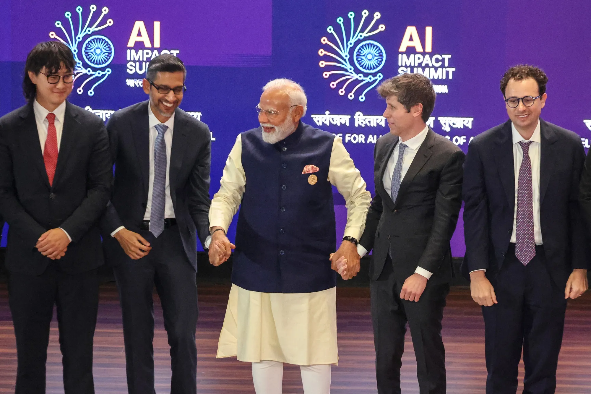 Narendra Modi, center, poses for photos with AI leaders at the summit&nbsp;.