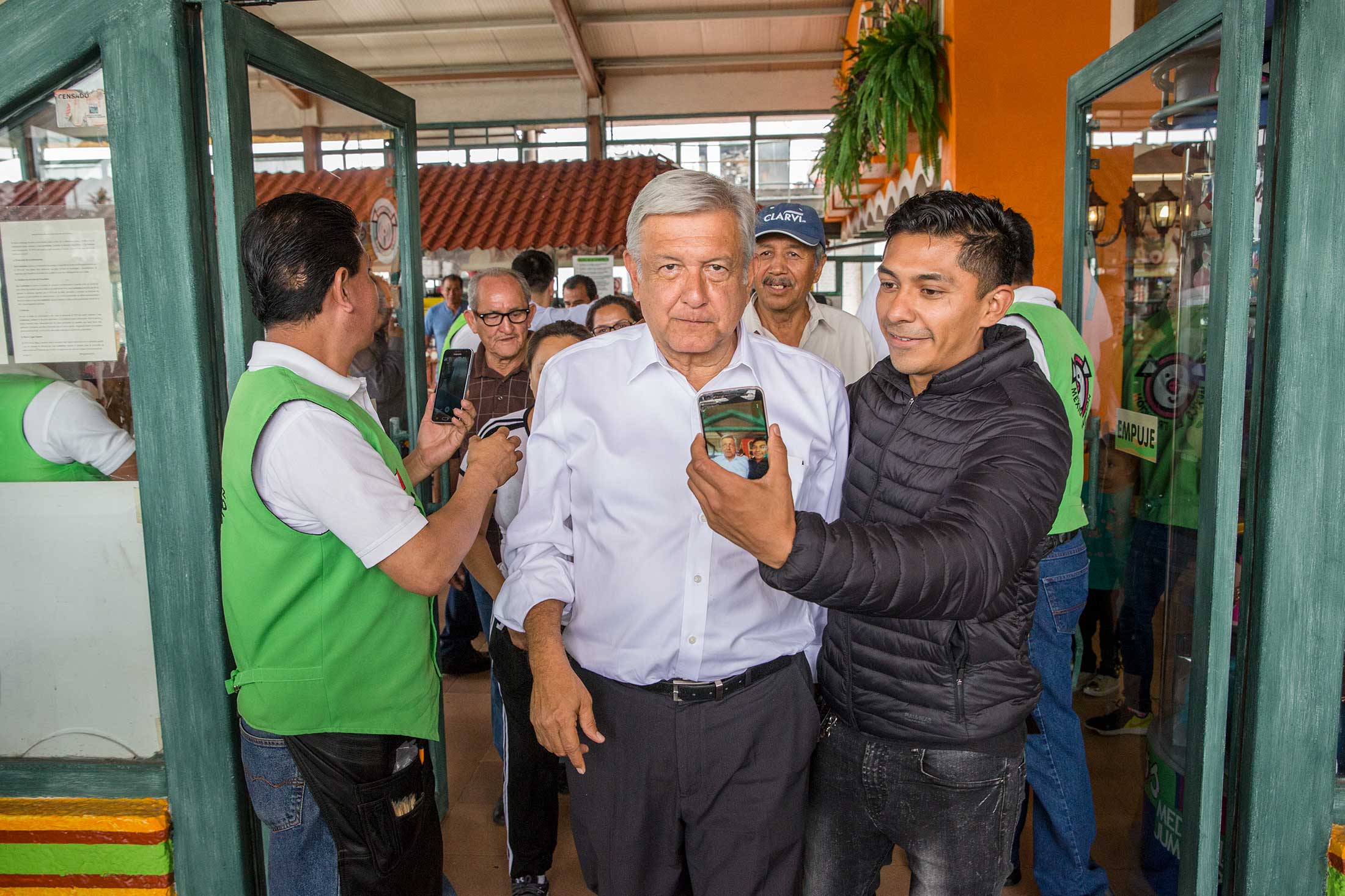 Andrés Manuel López Obrador, leader of the Morena political party and candidate for president of Mexico, leaves a restaurant surrounded by fans in Ixtapaluca, near Mexico City, on April 23, 2018.