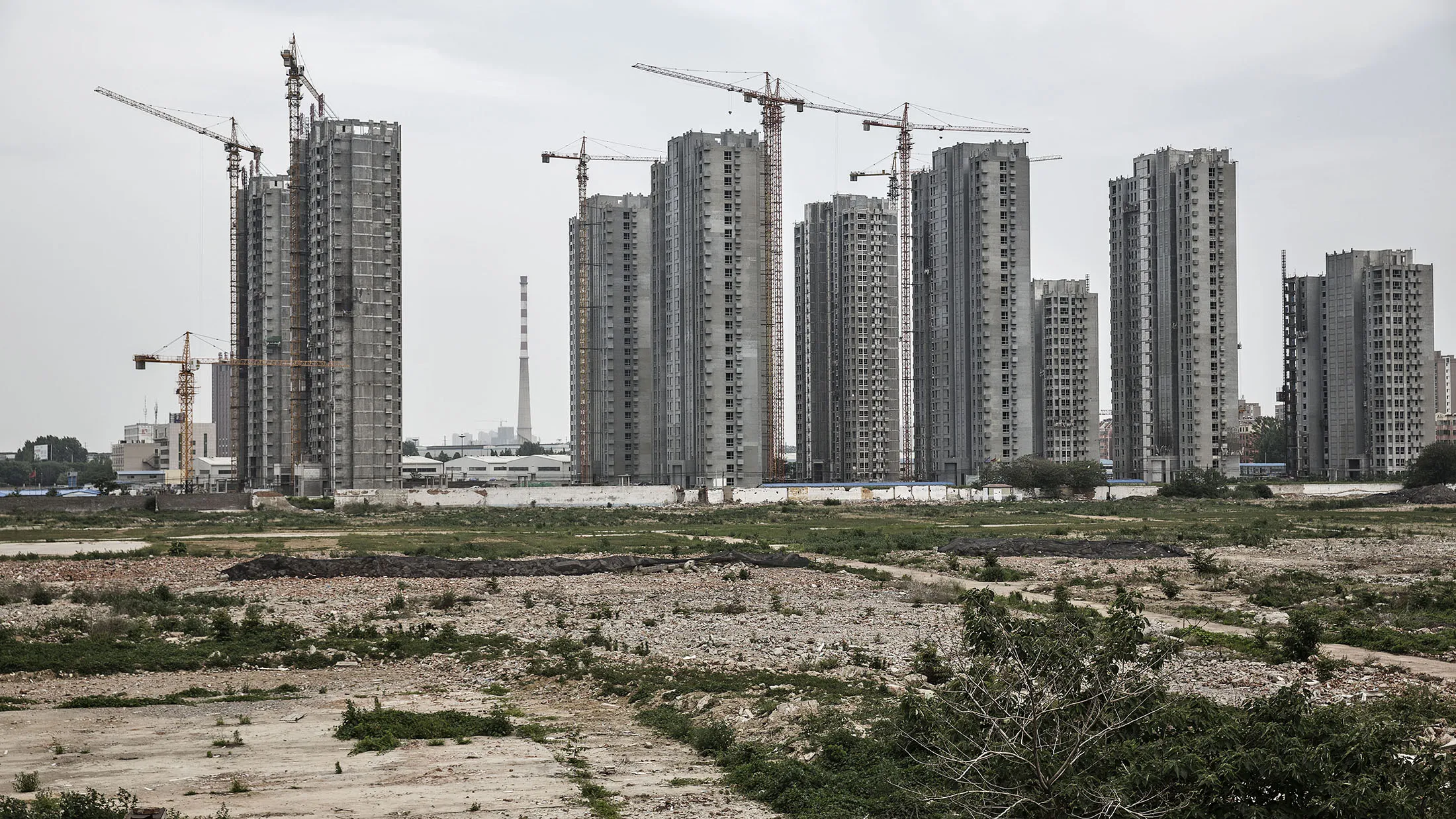 Residential buildings stand under construction in Jining, China on Monday, May 30, 2016. Shandong got a boost in the past from its proximity to Japan and South Korea, the source of much of its early investment. Now, it's trying to maintain the high growth rate needed to make the same leap they did: from middle- to high-income status.
