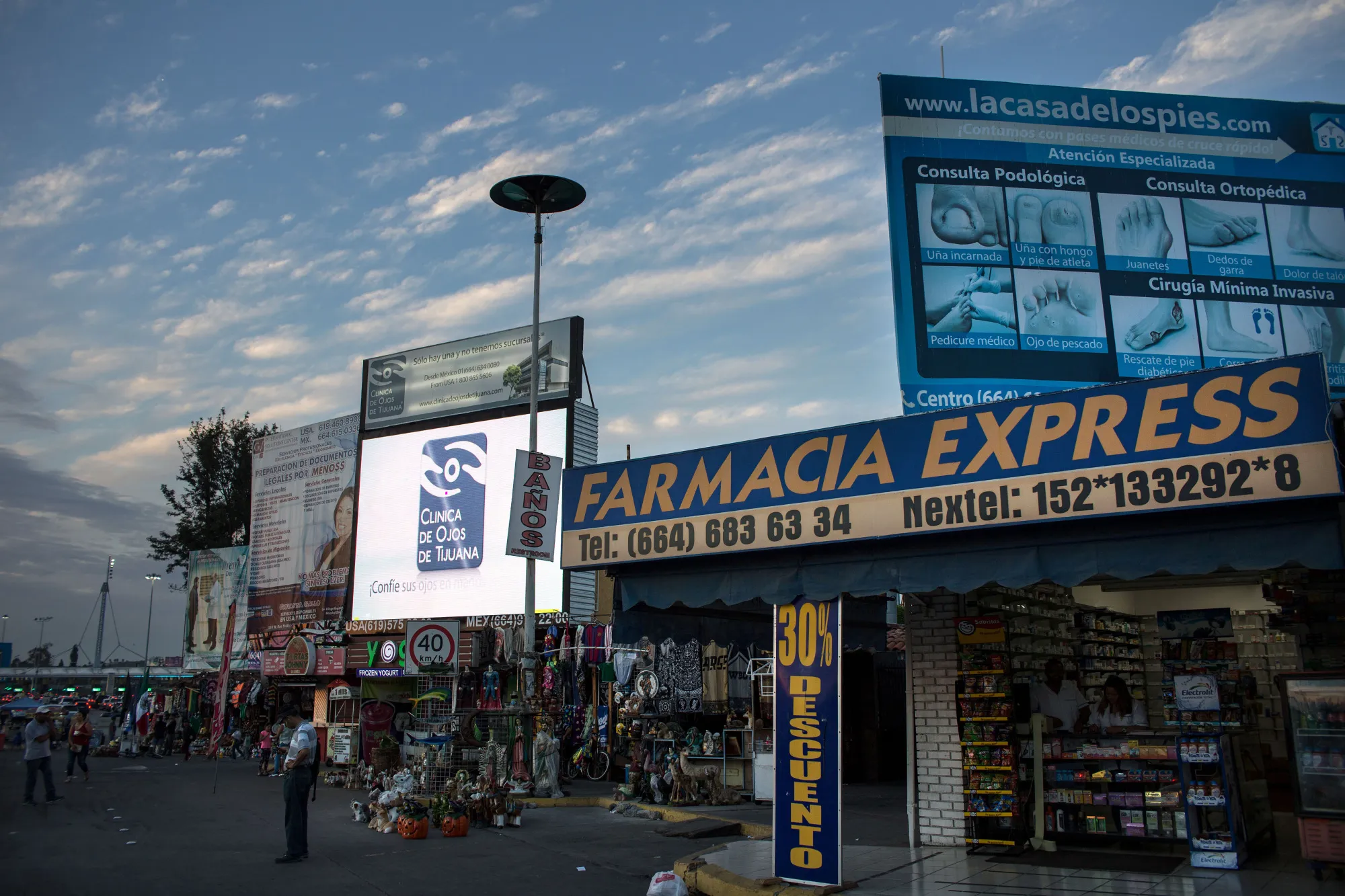 Billboards advertising medical services stand on display next to an express pharmacy in Tijuana, Mexico, on Sunday, Oct. 23, 2016.&nbsp;