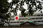 A Japanese flag flies outside the Bank of Japan headquarters in Tokyo.