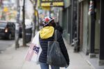 A shopper wears a protective mask on Queen St. West in Toronto on May 19.