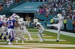 Miami Dolphins punter Thomas Morstead (4) sees the ball go backwards after attempting a punt during the second half of an NFL football game against the Buffalo Bills, Sunday, Sept. 25, 2022, in Miami Gardens, Fla. The play resulted in a safety for the Buffalo Bills. (AP Photo/Rebecca Blackwell)