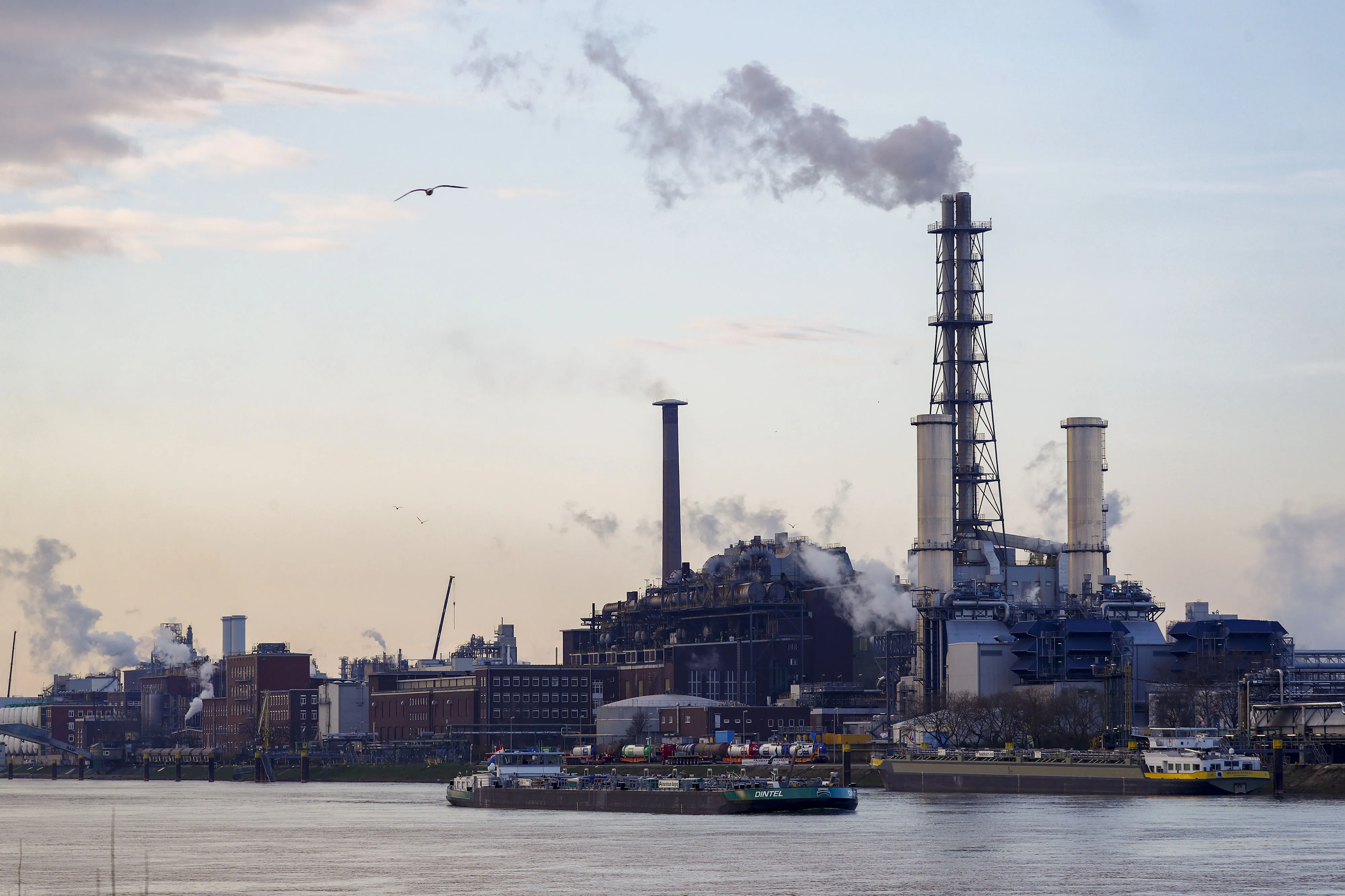 A barge sails by&nbsp;BASF SE’s&nbsp;chemical plant on the Rhine River in Ludwigshafen, Germany.