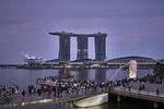 Crowds by the Merlion and Marina Bay Sands in Singapore.