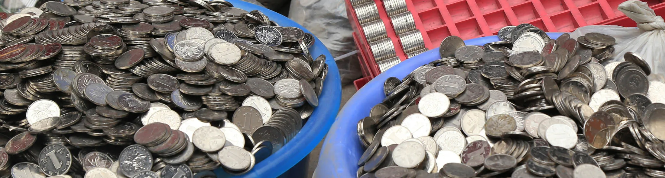 ZHENGZHOU, CHINA - JANUARY 11: (CHINA OUT) A worker counts one-yuan coins at the storehouse on January 11, 2016 in Zhengzhou, Henan Province of China. Mr. Zhang collected over 300,000 one-yuan coins from the coin-operated washing machines he managed, and he wanted to exchange the coins into paper money to pay salary for the workers. However the nearby banks all didn't agree to exchange them into banknotes immediately for the season that the bank could only exchange 2,000 to 3,000 coins per day and they had to confirm the coins were real.
