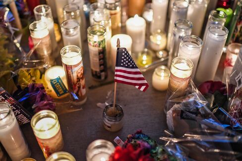 LAS VEGAS, NV - OCTOBER 3: A U.S. flag is placed in the middle of flowers and candles at a vigil that was held for the victims along the Las Vegas Strip a day after 59 people were killed and more than 500 wounded at the Route 91 Harvest Country Music Festival on Monday, October 2, 2017, in Las Vegas, NV. (Photo by Salwan Georges/The Washington Post via Getty Images)