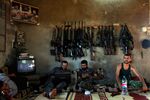 Free Syrian Army fighters sit in a house on the outskirts of Aleppo, Syria