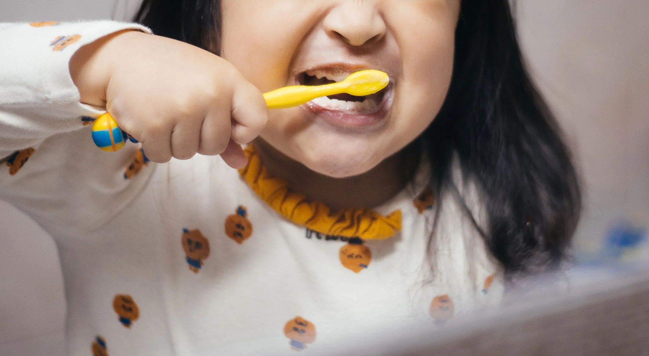 Young child brushing teeth