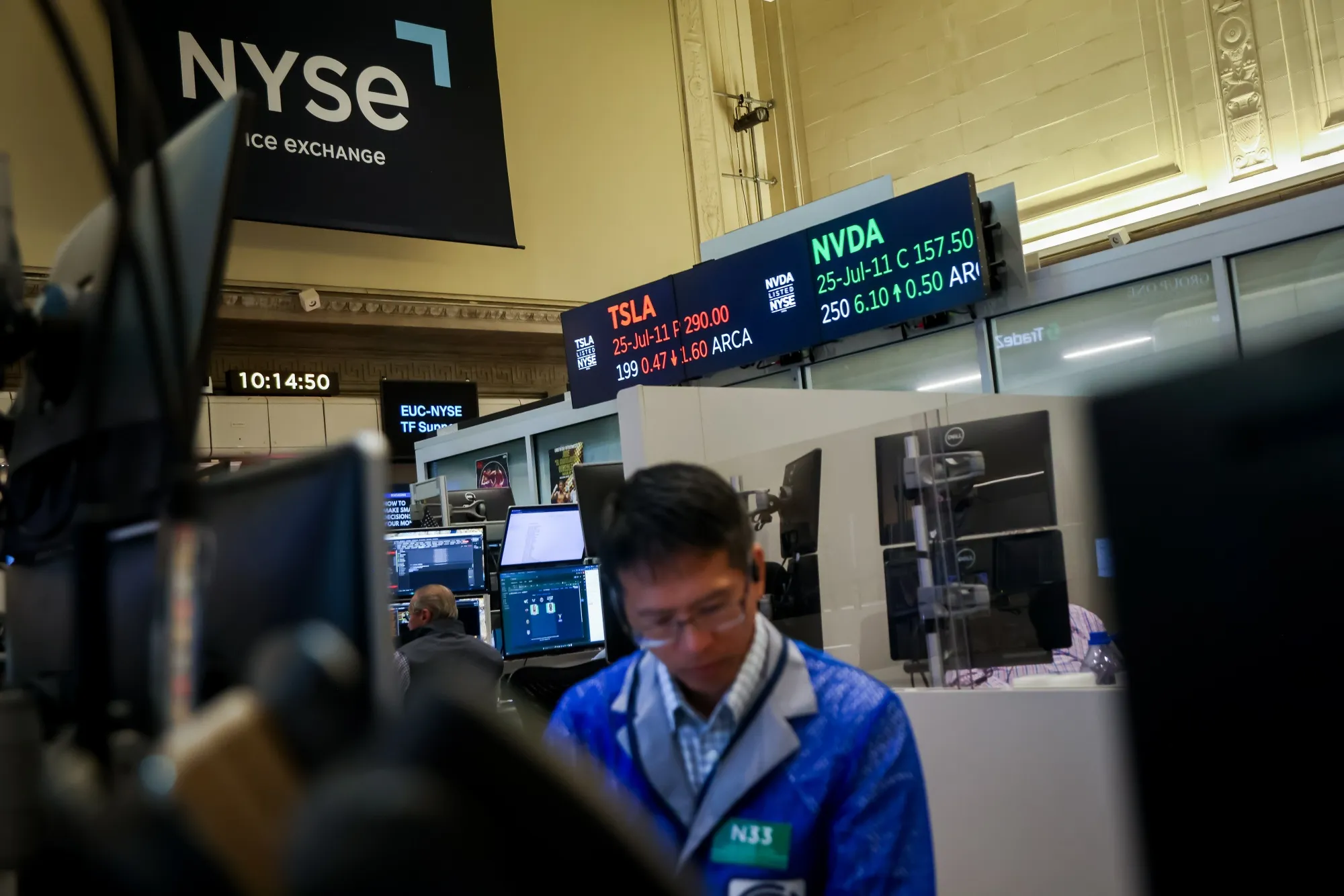 Tesla Inc. and Nvidia Corp. signage on an options contract ticker on the floor of American Stock Exchange (AMEX) at the New York Stock Exchange (NYSE) in New York, US, on Thursday, July 10, 2025.