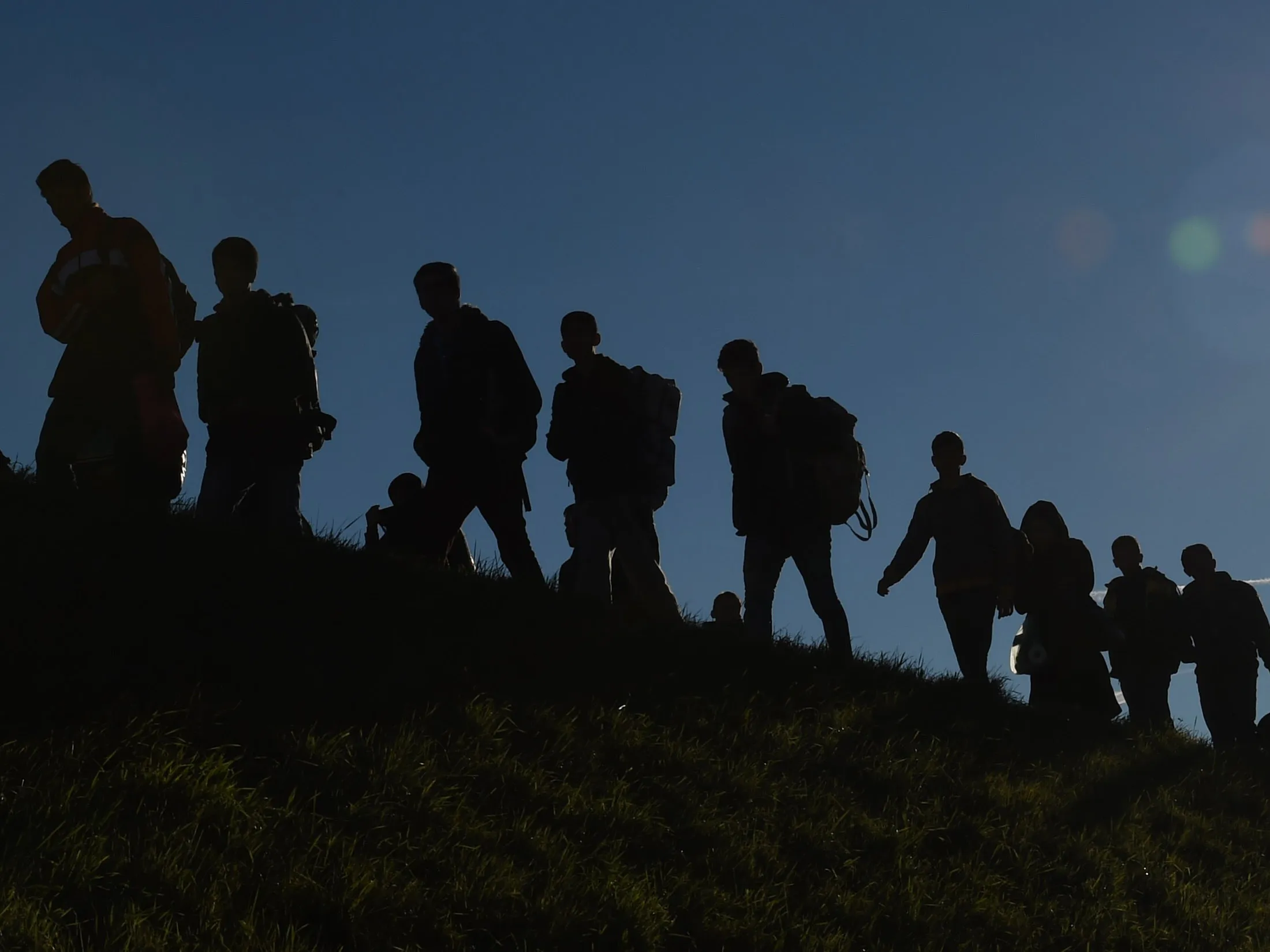 Migrants walk to a first registration point of the German federal police after they crossed the Austrian-German border in the small Bavarian village of Simbach, southern Germany, on Nov. 2, 2015.