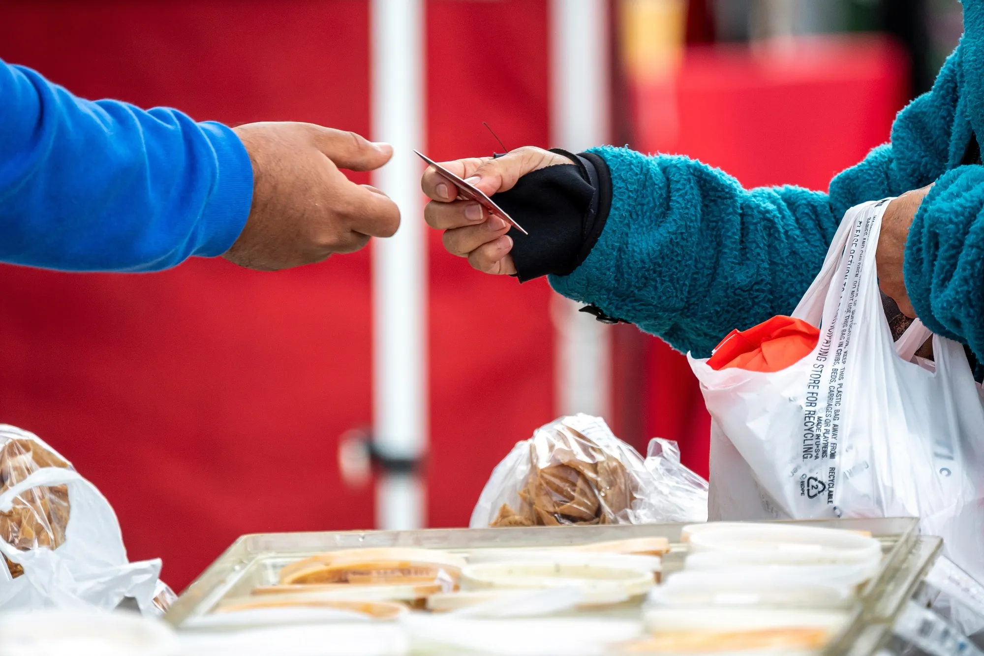 A shopper pays with a credit card at the farmer's market in San Francisco.