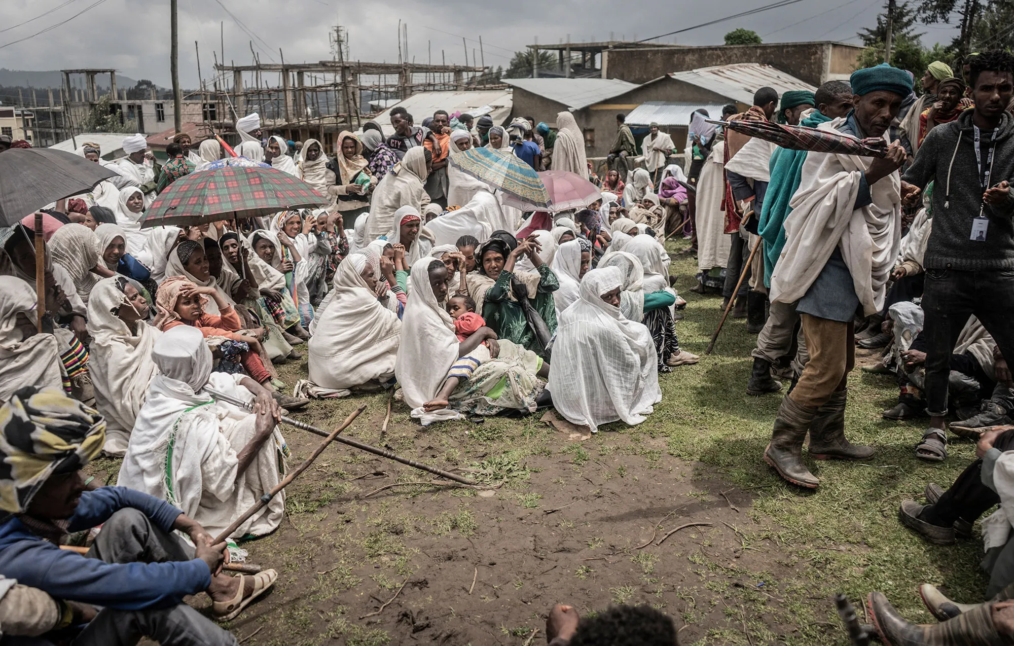 People who fled the war from May Tsemre, Addi Arkay and Zarima gather in a temporary internally displaced people’s camp to receive bags of wheat from the World Food Programme&nbsp;in Debark, Ethiopia, on Sept.&nbsp;15.
