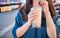 A young woman is drinking a plastic cup of bubble milk tea with a straw at a night market in Taiwan, Taiwan delicacy, close up.