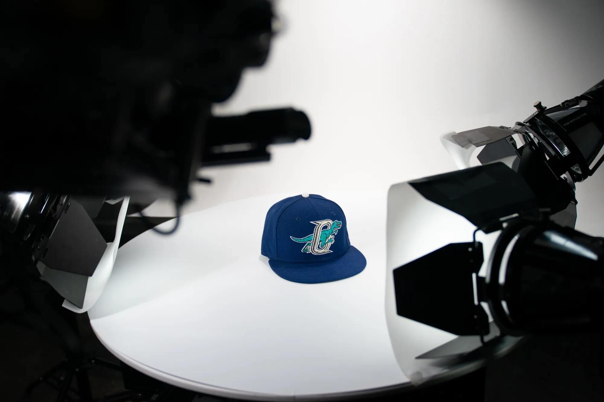 The robot shoots a ball cap at the Square Photo Studio.