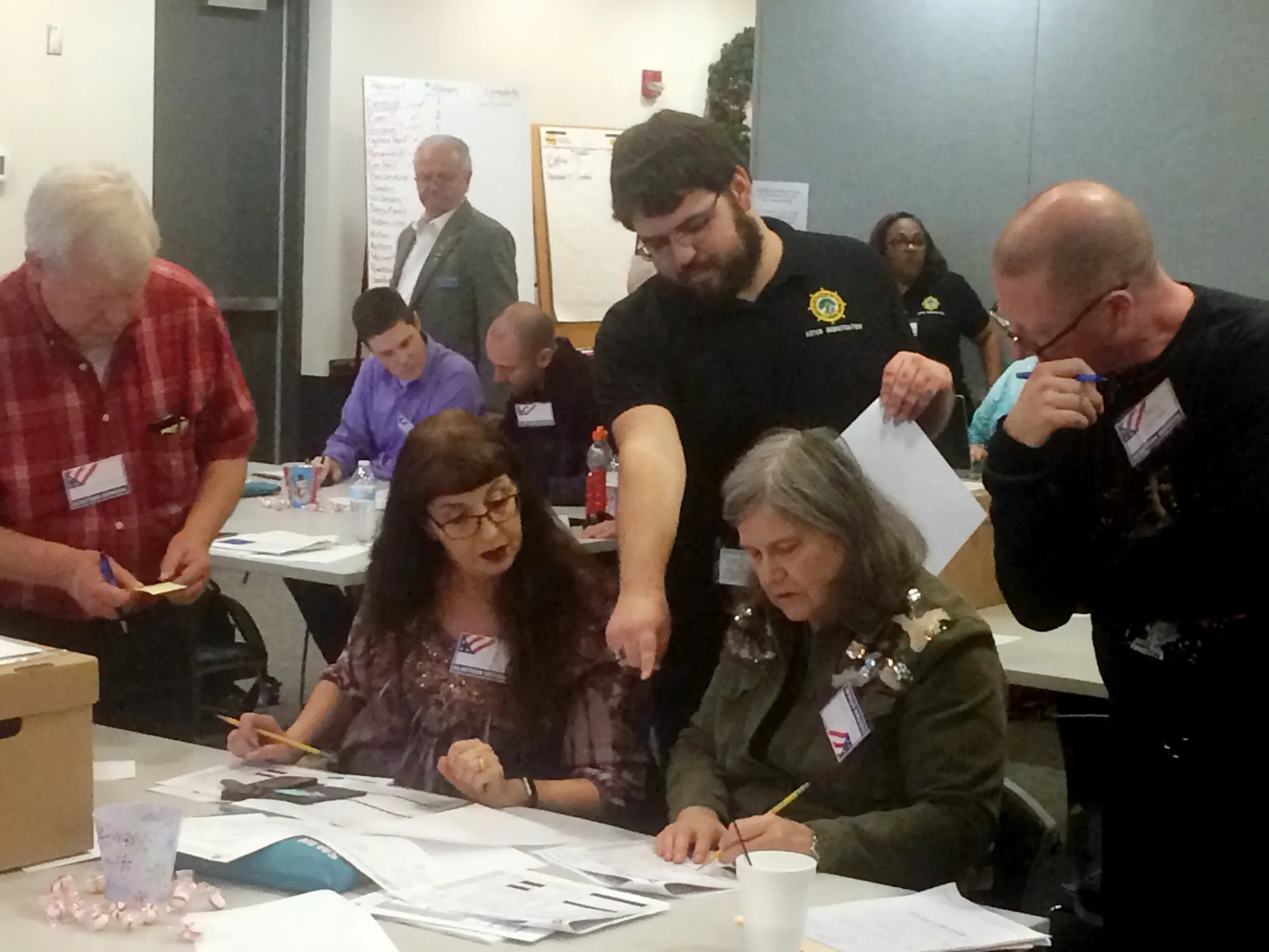 Election officials examine ballots during a recount for a House of Delegates race in Newport Newson, Virginia, on Dec. 19.