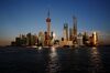 Skyscrapers and high rise towers, including the Oriental Pearl Tower, center, send reflections across the Huangpu River in Pudong, a district of Shanghai, China.