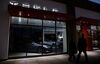 Pedestrians walk past a closed Tesla Inc. store in Palm Desert, California.