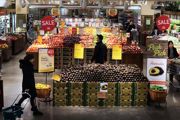 Customers shop at a Whole Foods Market Inc. store in New York