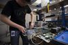 Libin Bai, an electrical test engineer intern at Facebook Inc., puts together a server to be tested at the company's hardware labs in Menlo Park, California, U.S., April 7, 2014.