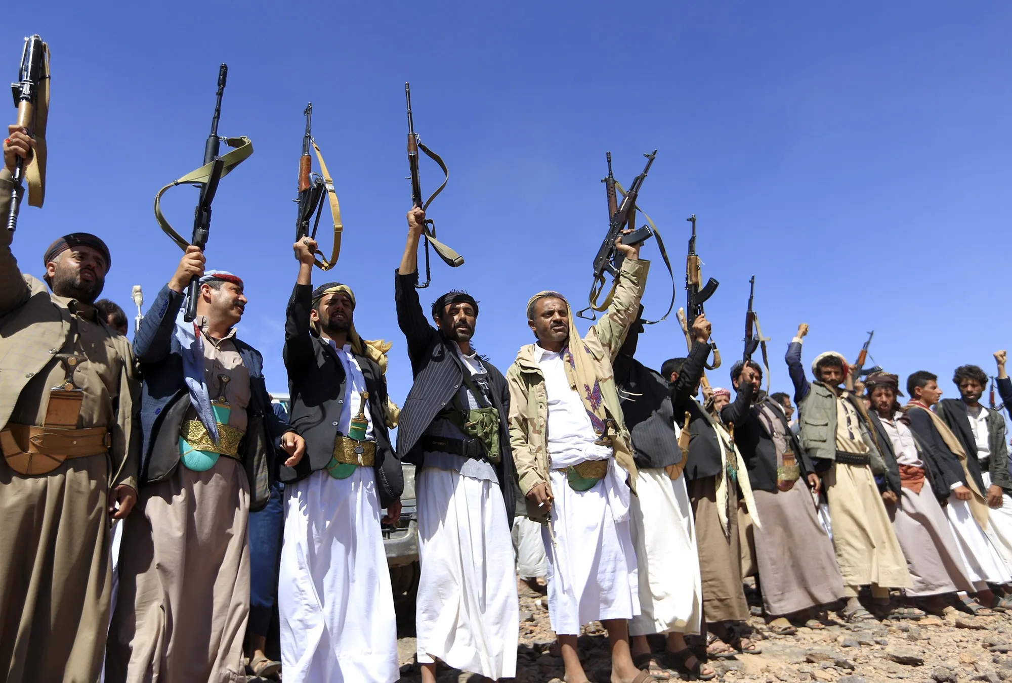Armed Yemeni men raise their weapons as they gather near the capital Sanaa to show their support to the Shiite Huthi movement against the Saudi-led intervention on Feb. 21, 2019.