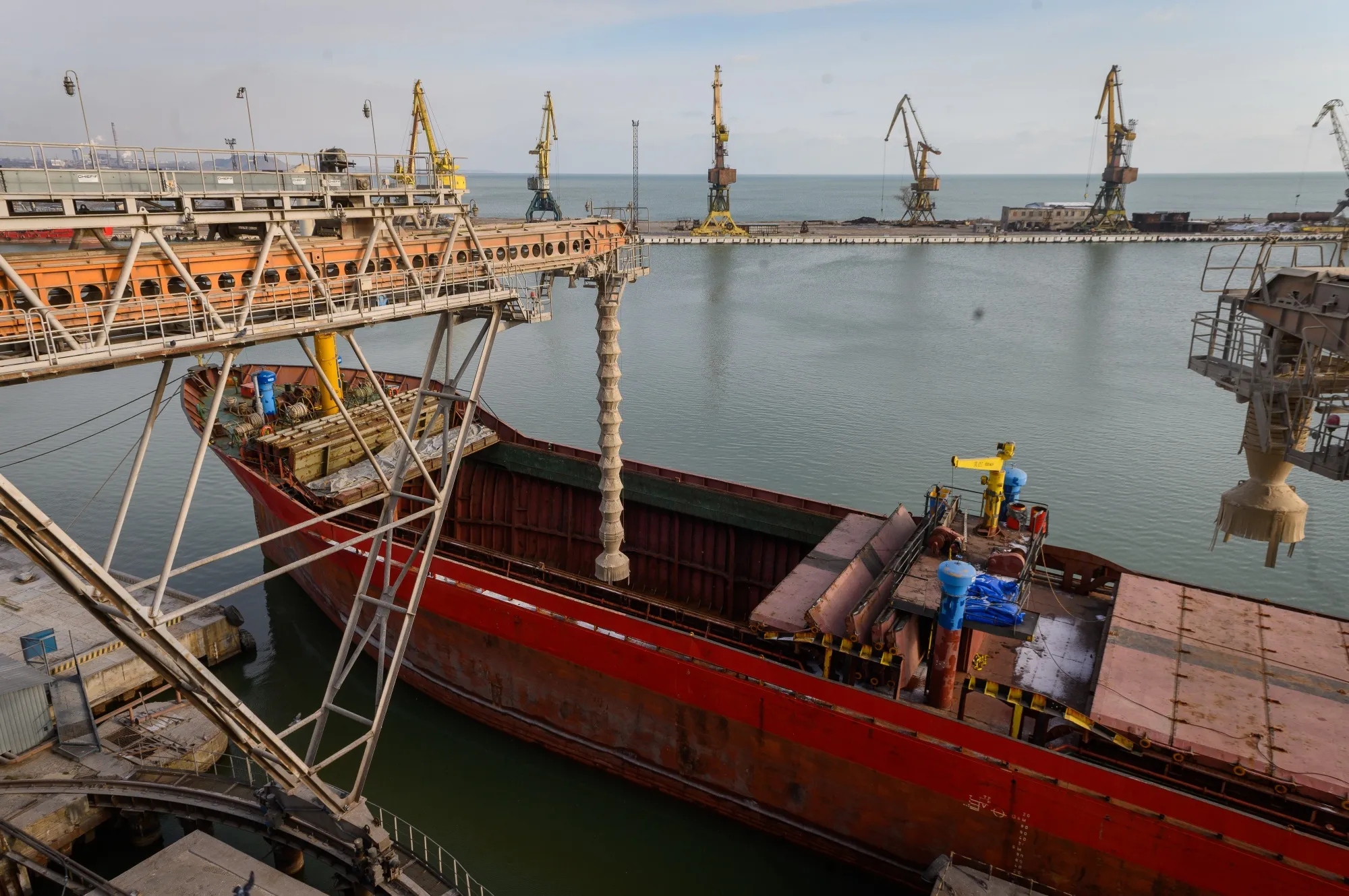 A cargo vessel&nbsp;is loaded with grain at a terminal at the Port of Mariupol in January.