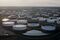 Oil storage tanks stand in this aerial photograph taken above Cushing, Oklahoma, U.S., on Tuesday, March 24, 2015. The fastest oil-inventory growth on record at the main U.S. hub may be about to end, easing concern that storage limits will be strained. Photographer: Daniel Acker/Bloomberg