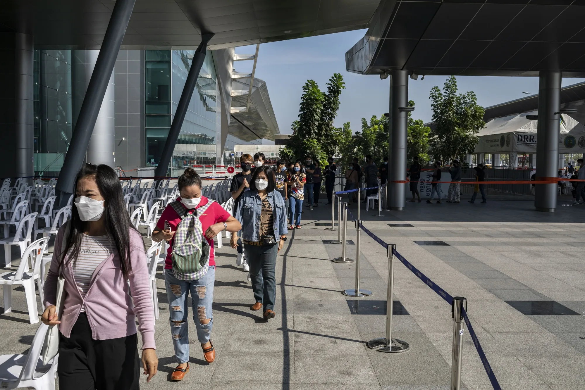 Members of the public wait in line to receive the Pfizer-BioNTech Covid-19 vaccine at a vaccination center set up at the Bang Sue Grand Station in Bangkok, Thailand, on Dec. 20.