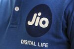 The logo of Reliance Jio, the mobile network of Reliance Industries Ltd., is seen on an employees shirt at a store in Mumbai.