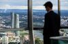 FRANKFURT AM MAIN, GERMANY - OCTOBER 05: Two men stand at the viewing platform of the 'Maintower' and look to the headquarters of the European Central Bank (ECB) on October 5, 2016 in Frankfurt, Germany. Banks across Europe are struggling as their profits have fallen amid an ongoing period of low interest rates, and many, including Commerzbank and Deutsche Bank of Germany, ING and ABN Amro of Holland, and Banco Popular of Spain, are responding by slashing thousands of jobs in an effort to cut costs. (Photo by Thomas Lohnes/Getty Images)